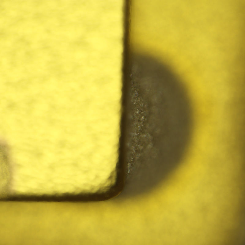 Corner of resonator with focal plane at adhesive layer