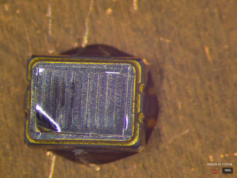 TCXO package with one corner beginning to peel up